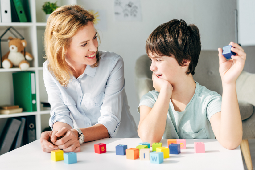 Teacher and child smiling. 