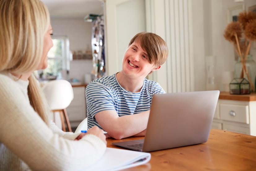 Teacher working with special needs boy.