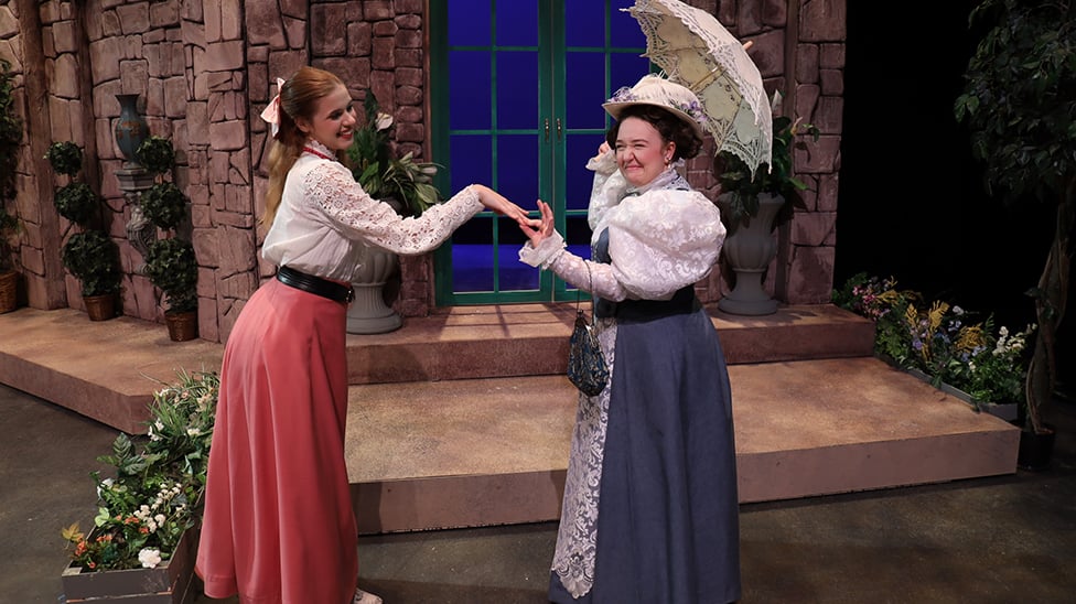 Two actors in a play on stage.