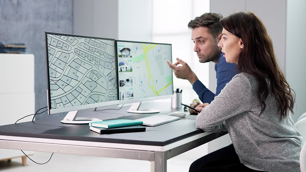Two people looking at a computer.