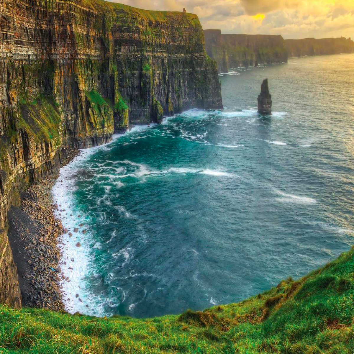 Green, rocky cliff on the edge of an ocean in Ireland.