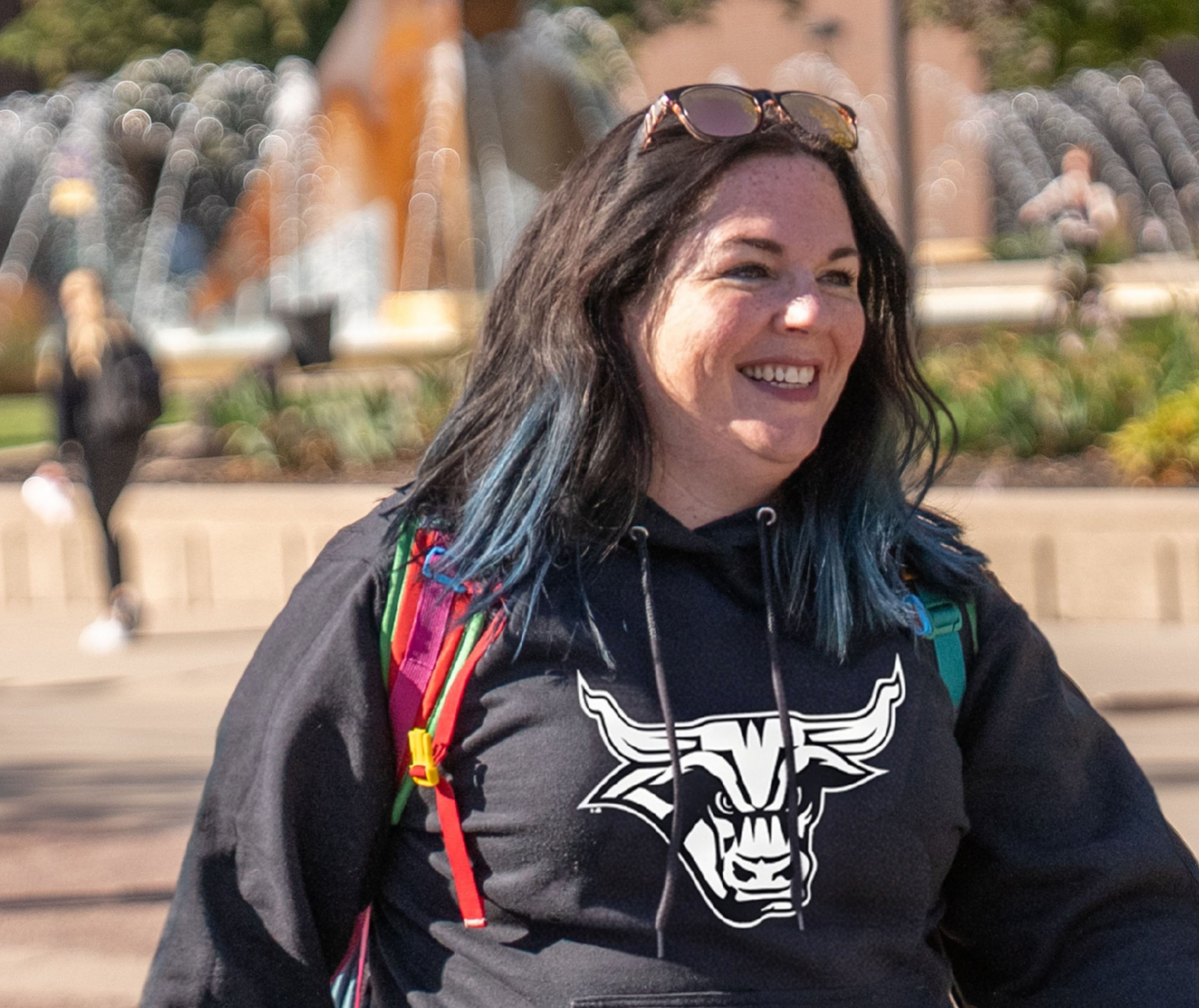 student smiling outside on the msu campus by the fountain