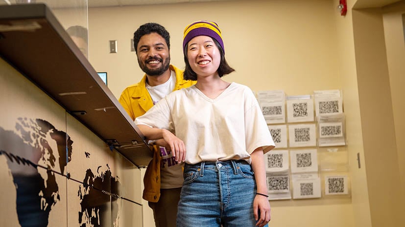 Two students standing at the front desk of the Kearney International Center office located in the CSU