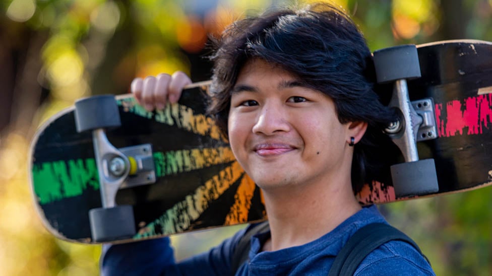 a person holding a skateboard