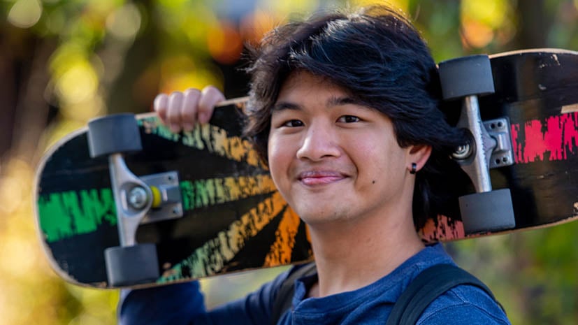a person holding a skateboard