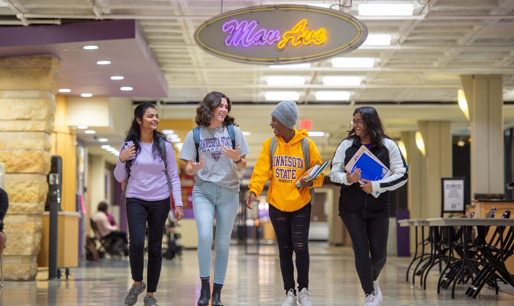 image of four students walking on campus in Mav Ave