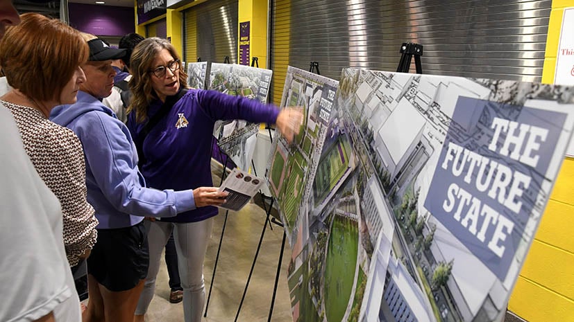 Community members and guests looking at the Future State Poster boards with the renderings.