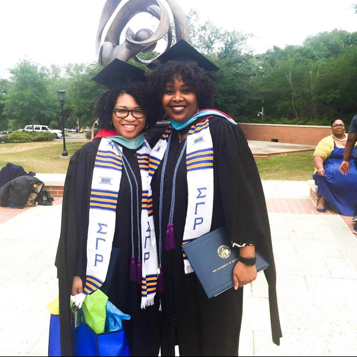 Felicia Smith and Chalandra Gooden in their graduation regalia from the University of South Alabama