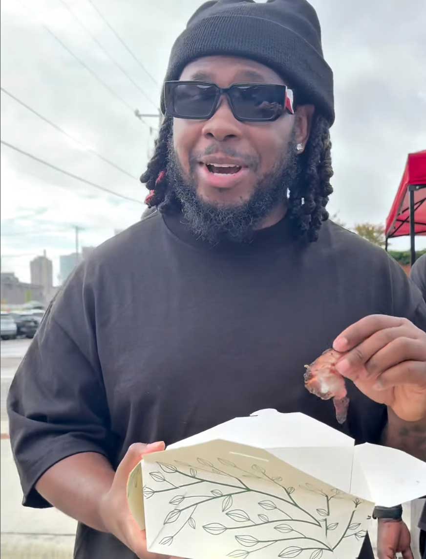 Davon Good eating ribs at a farmer's market