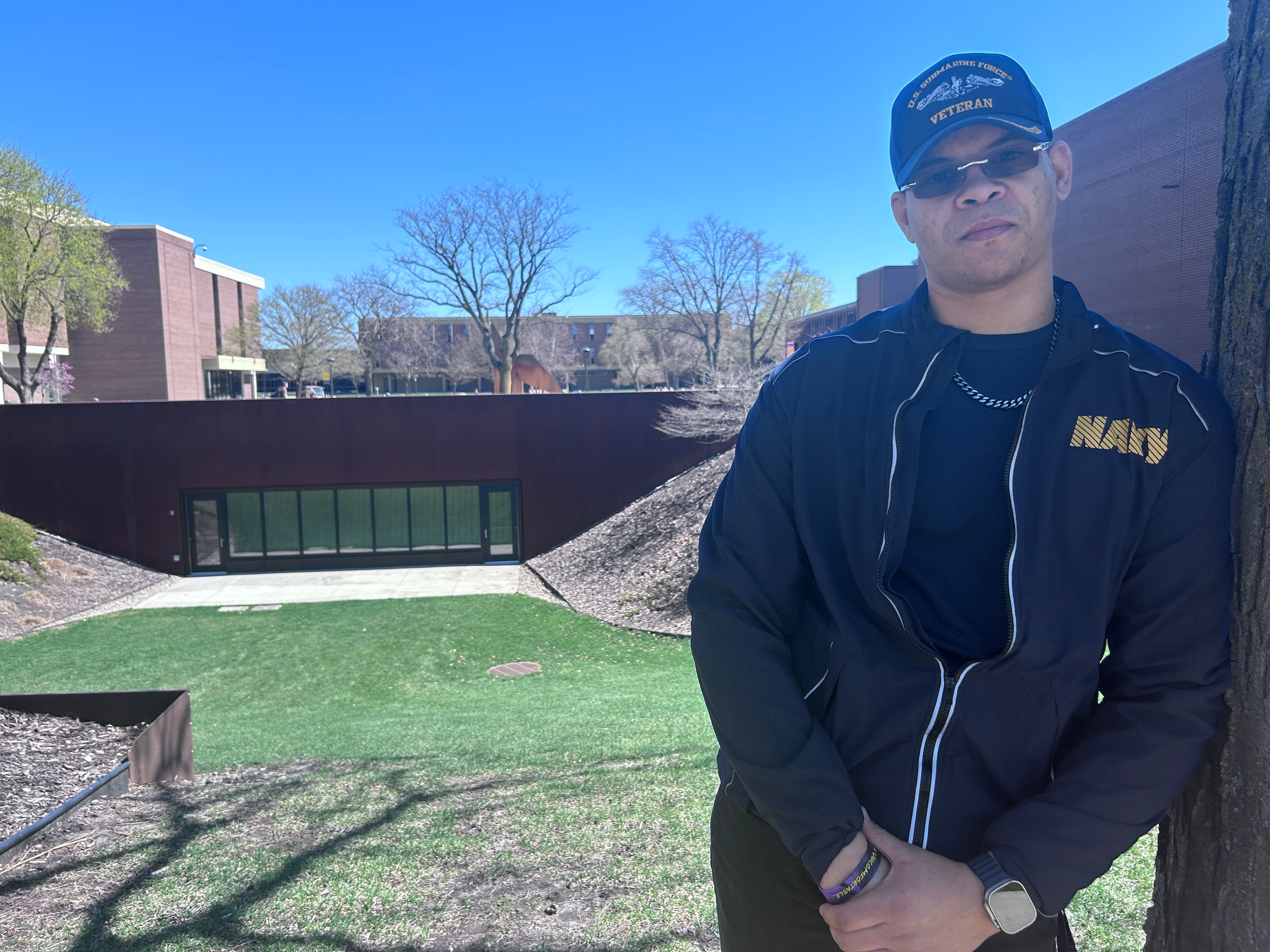 DaVonte McClam navy veteran and msg senior posing on campus in a navy tee and cap