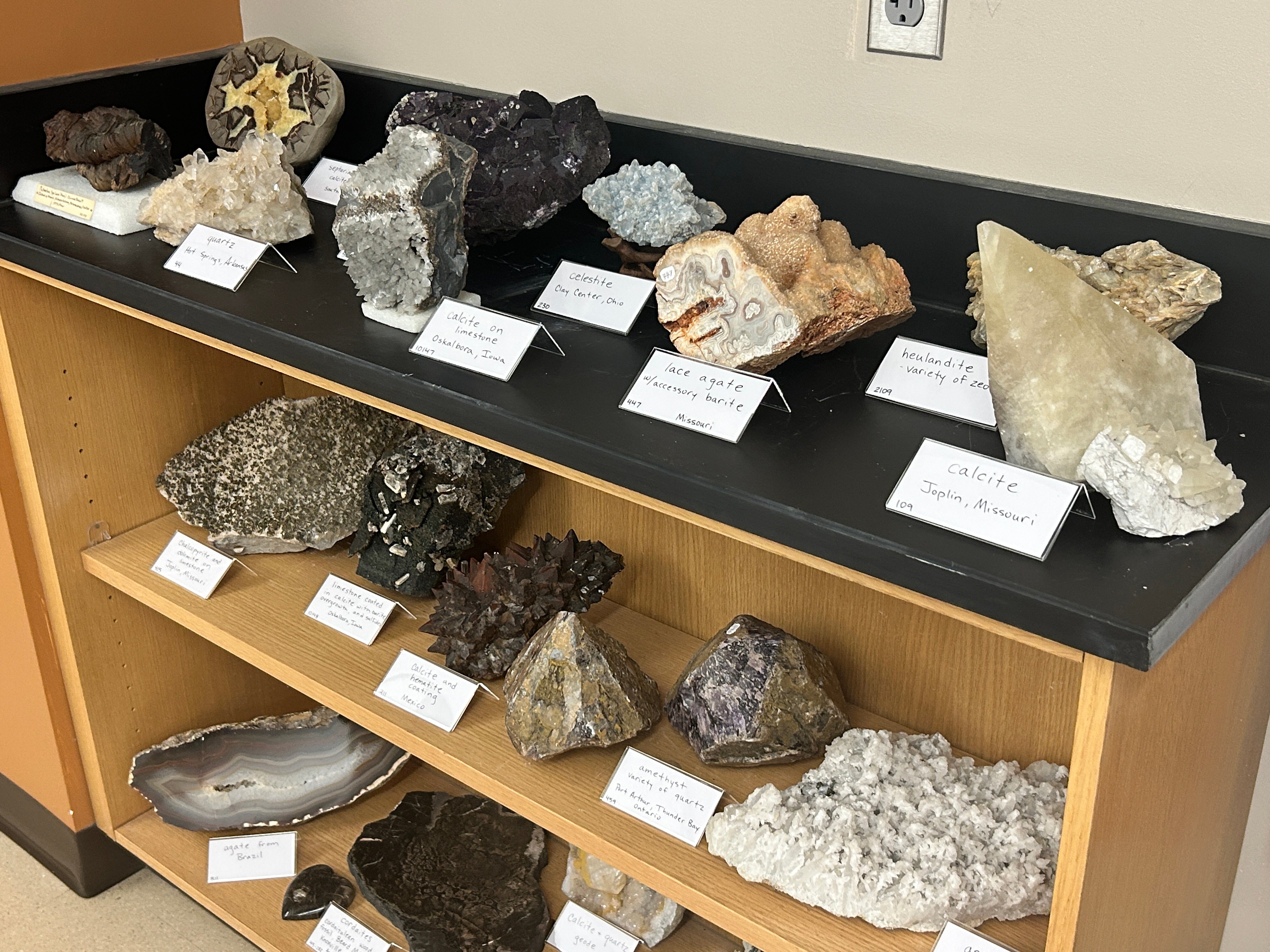 3 shelves containing a collection of Minerals Geodes