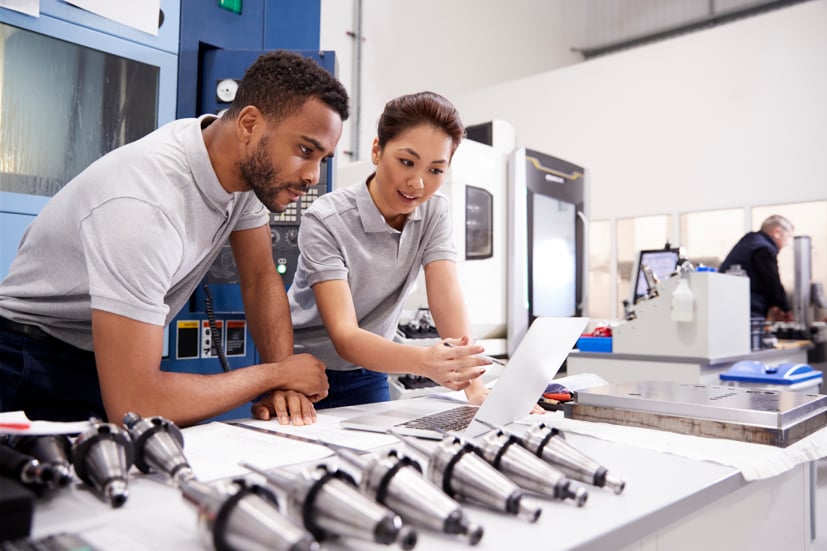 Man and women engineer looking at a computer. 