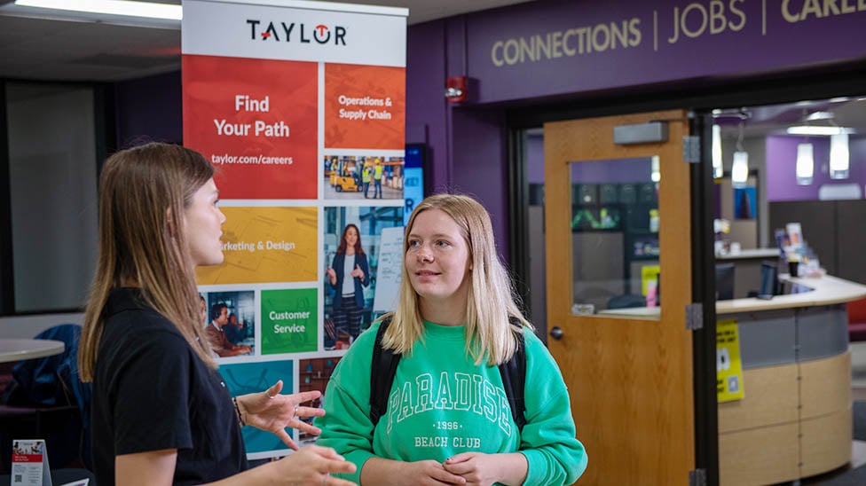 student talking to an employer outside of the Career Development Center