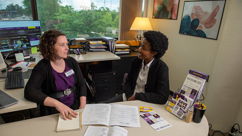 Career advisor speaking with a student