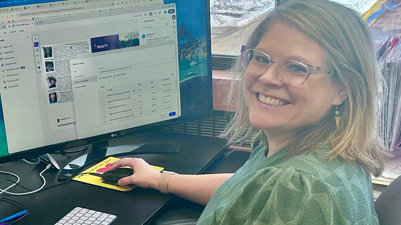 Brook Burk, social word department chair sitting at her computer and smilling