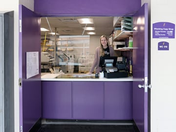 a person standing behind a counter
