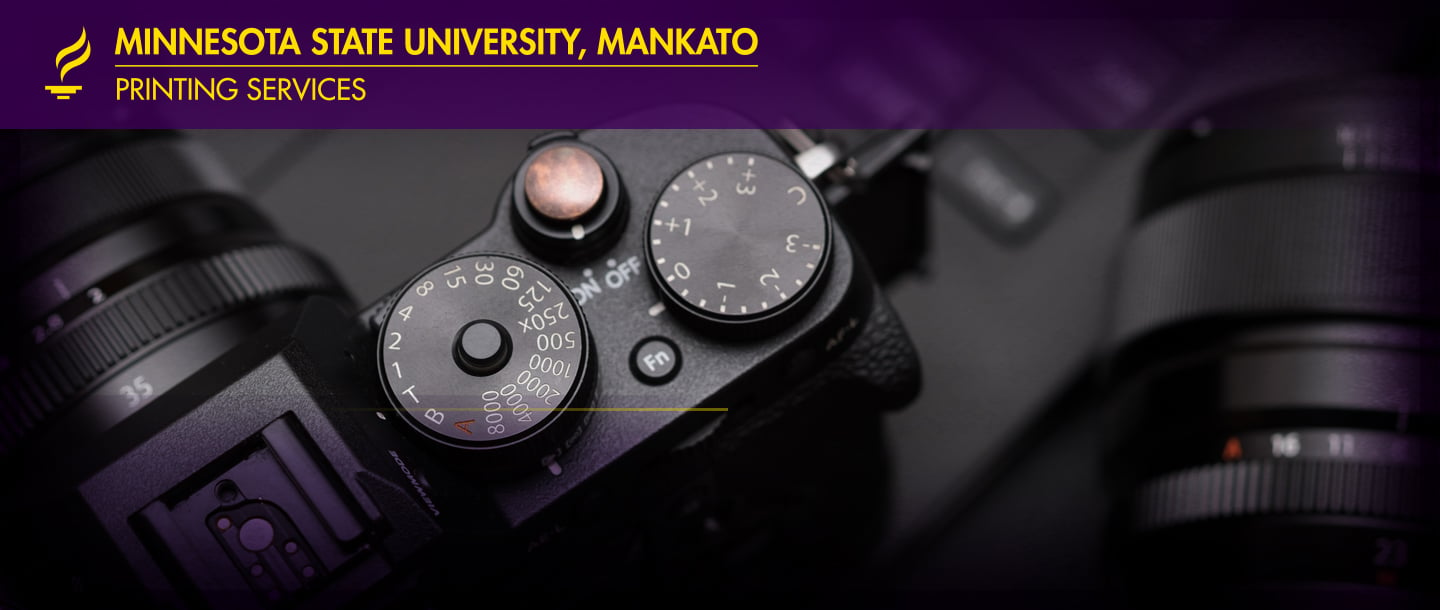 Minnesota State University, Mankato Creative Production camera closeup focused on the power button, mode dial, ISO control and lens