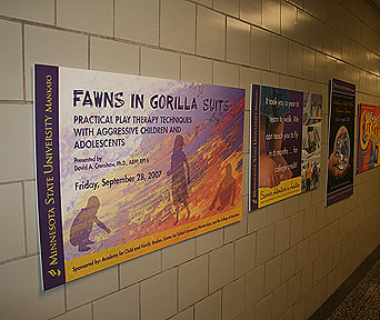Fawns in Gorilla Suits, practical play therapy techniques with aggressive children and adolescents poster pasted in interior wall of MNSU building