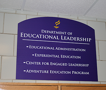 Department of Educational Leadership board hung in a wall