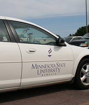 Van with the Minnesota State University logo painted on the front door 