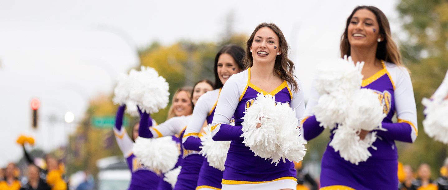 The Maverick cheerleaders walking in the homecoming parade