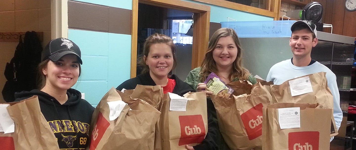 Members of Circle K International stand with bags full of groceries to give as donations to the Campus Kitchen at MSU, Mankato.