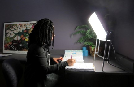 student studying in front of bright light