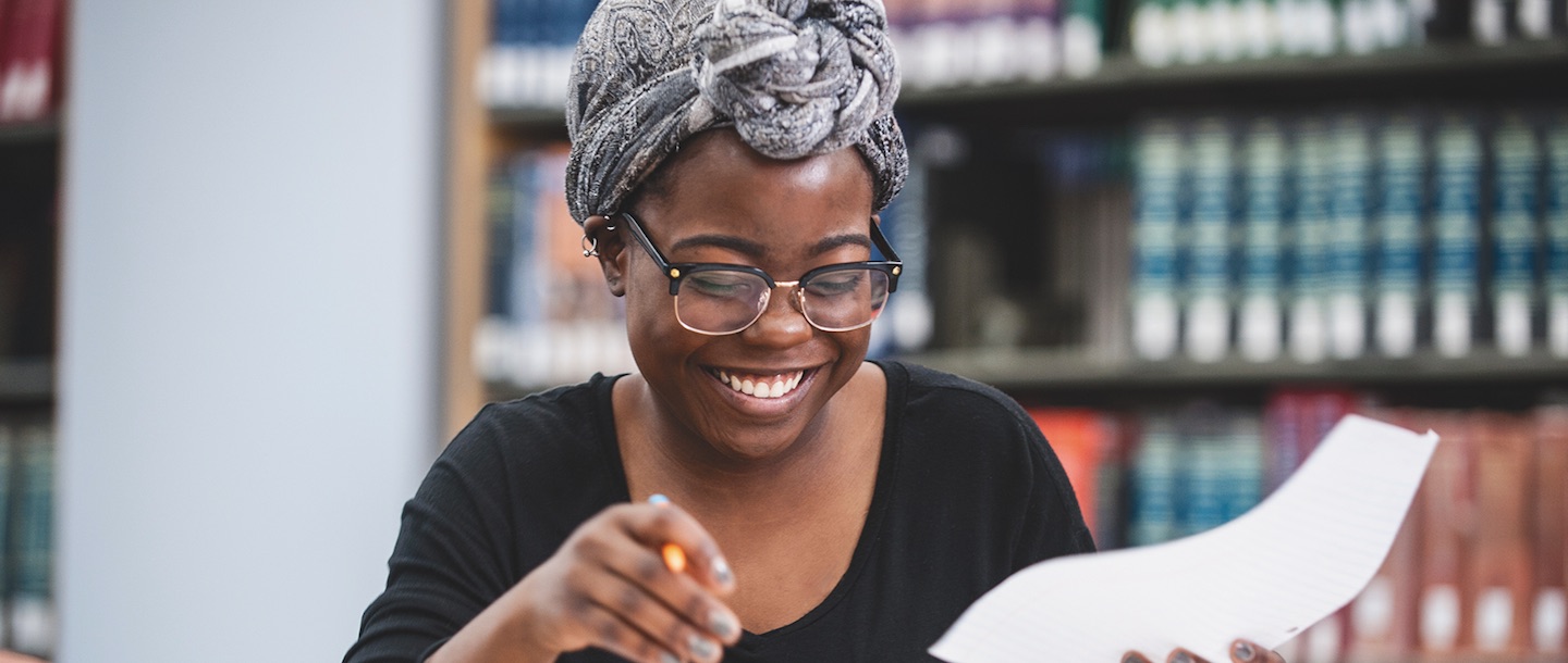 student smiling at library