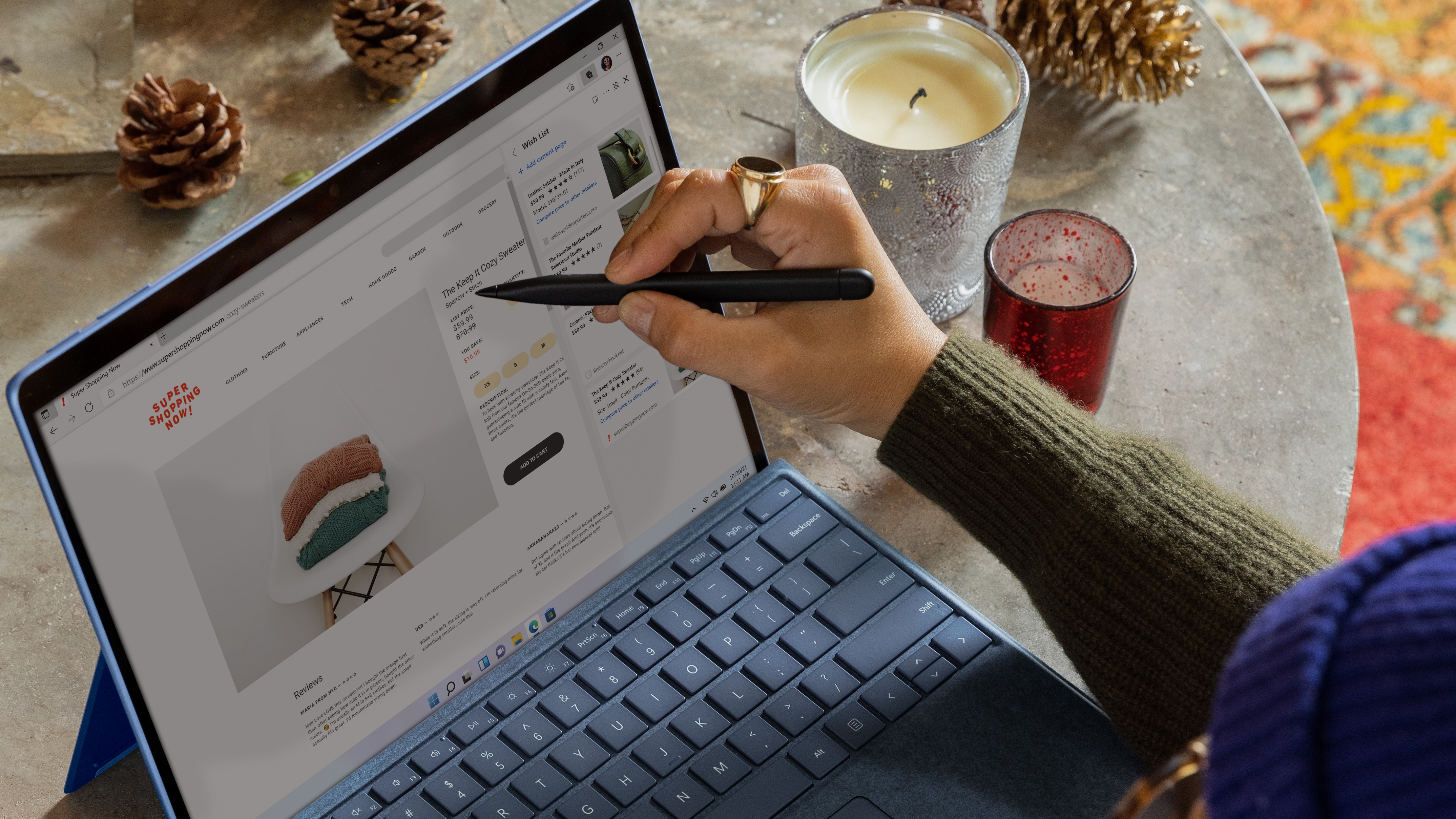 Stock photo of a person doing Business-related work on a tablet that is on a table with Christmas-themed decorations.