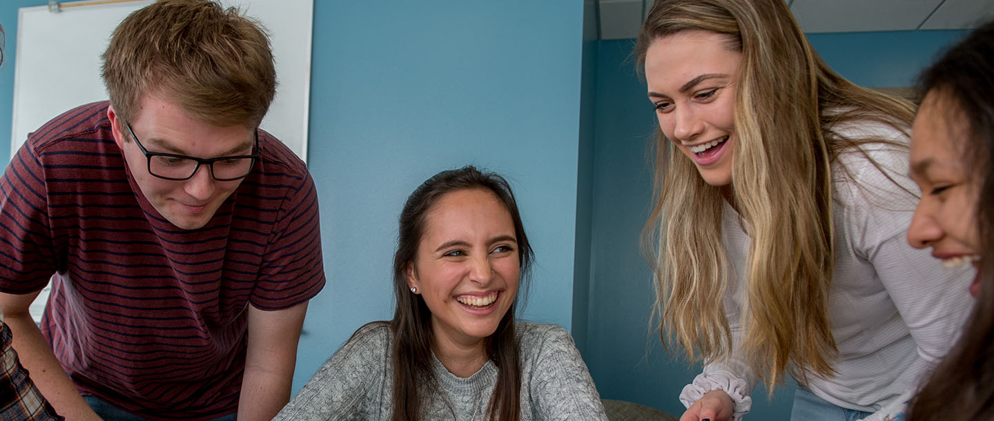 four students laughing