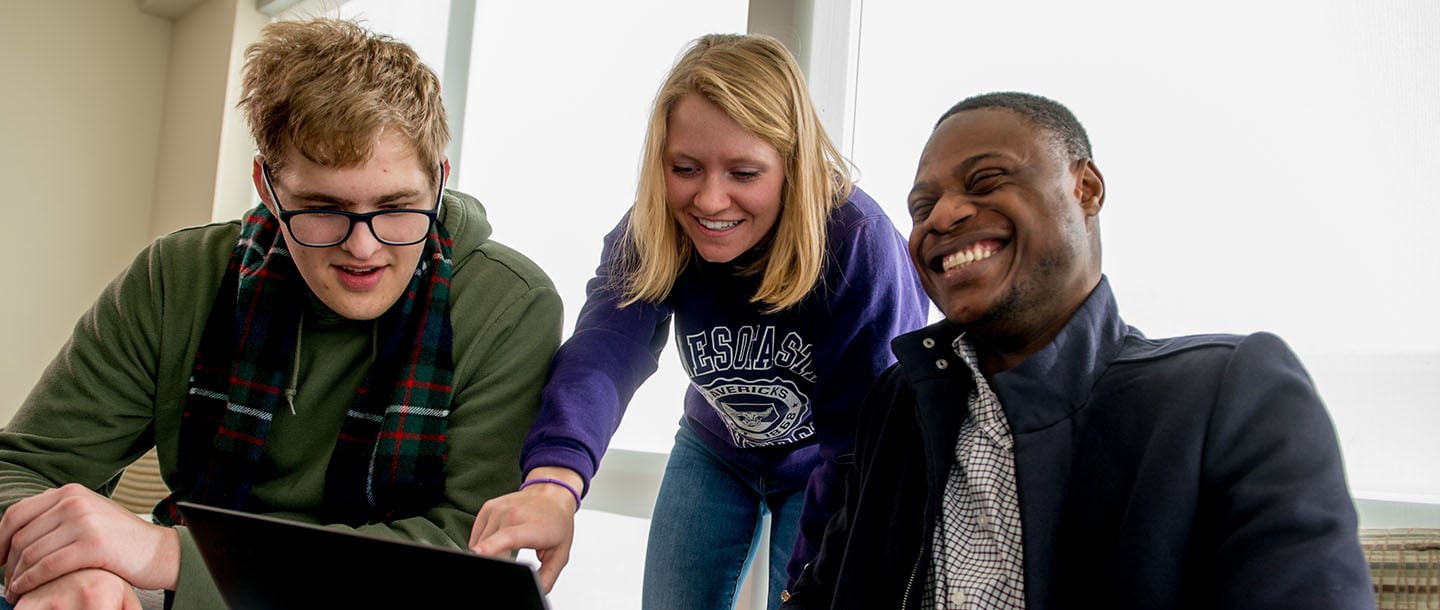 three students studying together
