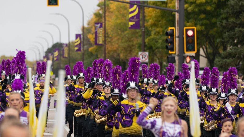 The Maverick Machine marching band performing along Stadium road at the homecoming parade