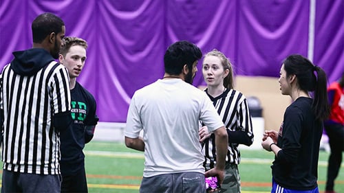 Student officials officiating an intramural sports game