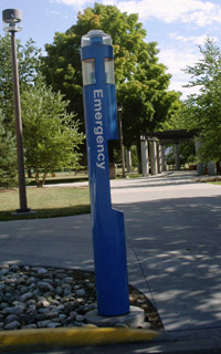Emergency telephone pole at a sidewalk on campus
