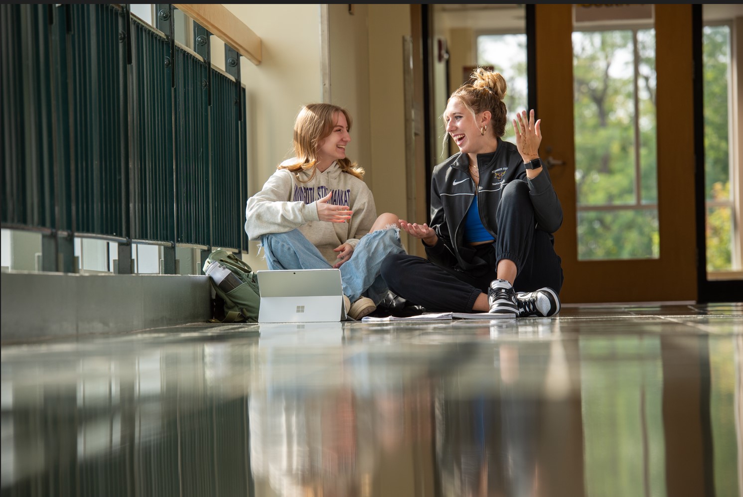 two women sitting on the floor