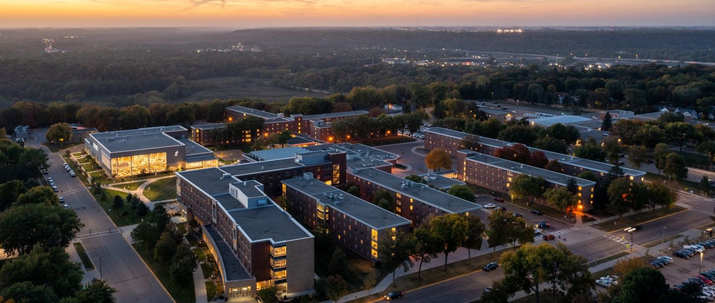 An aerial view of residential life housing and dining on campus at dusk