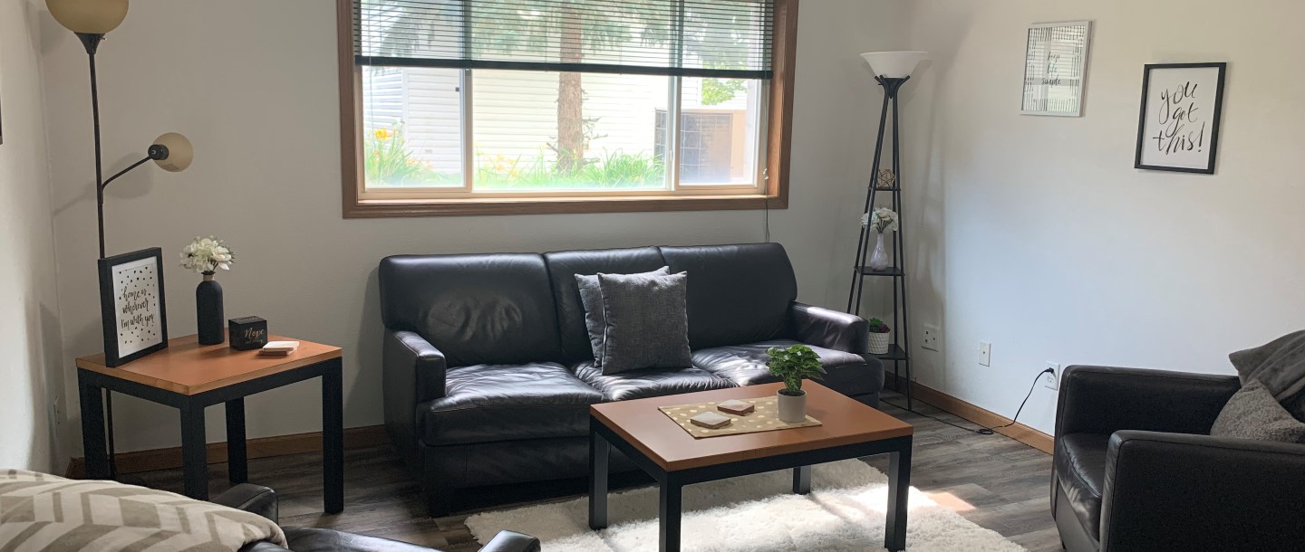 A living room with lamps, two sofa and somes tables