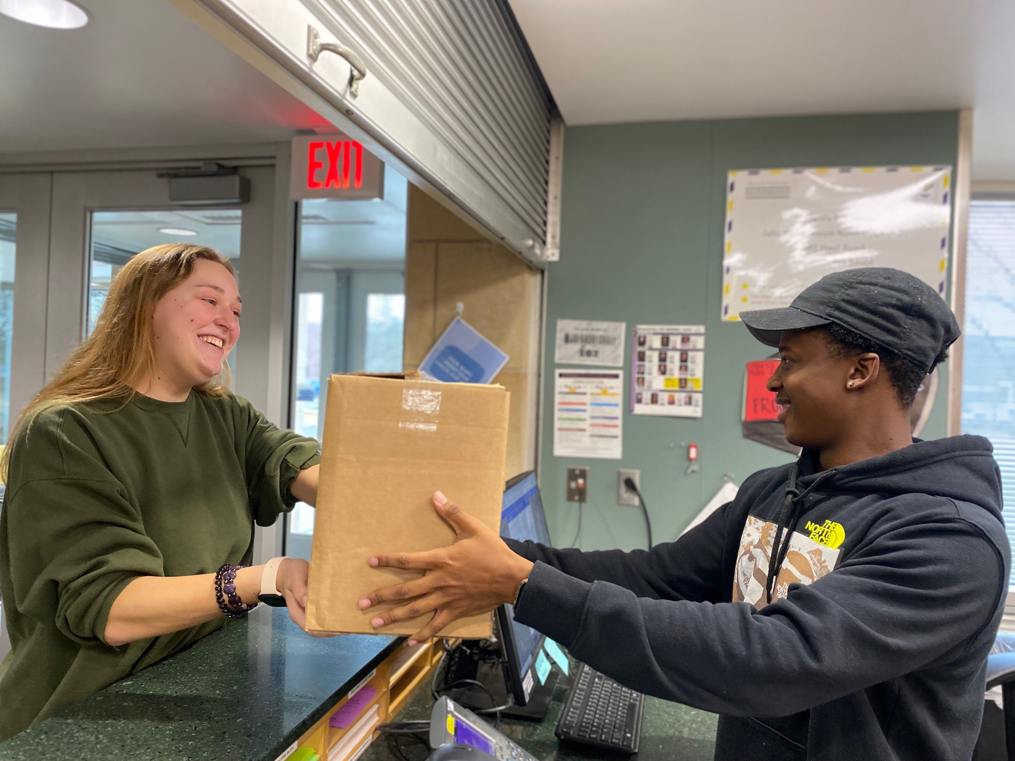 a person handing a box to a person