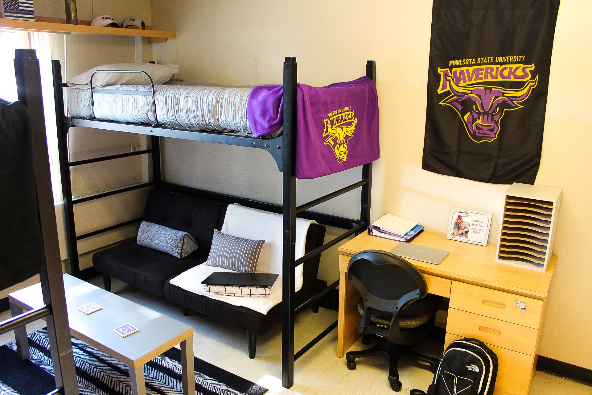 Basic Crawford room with two bunk beds, two desk with chairs and a coffee table