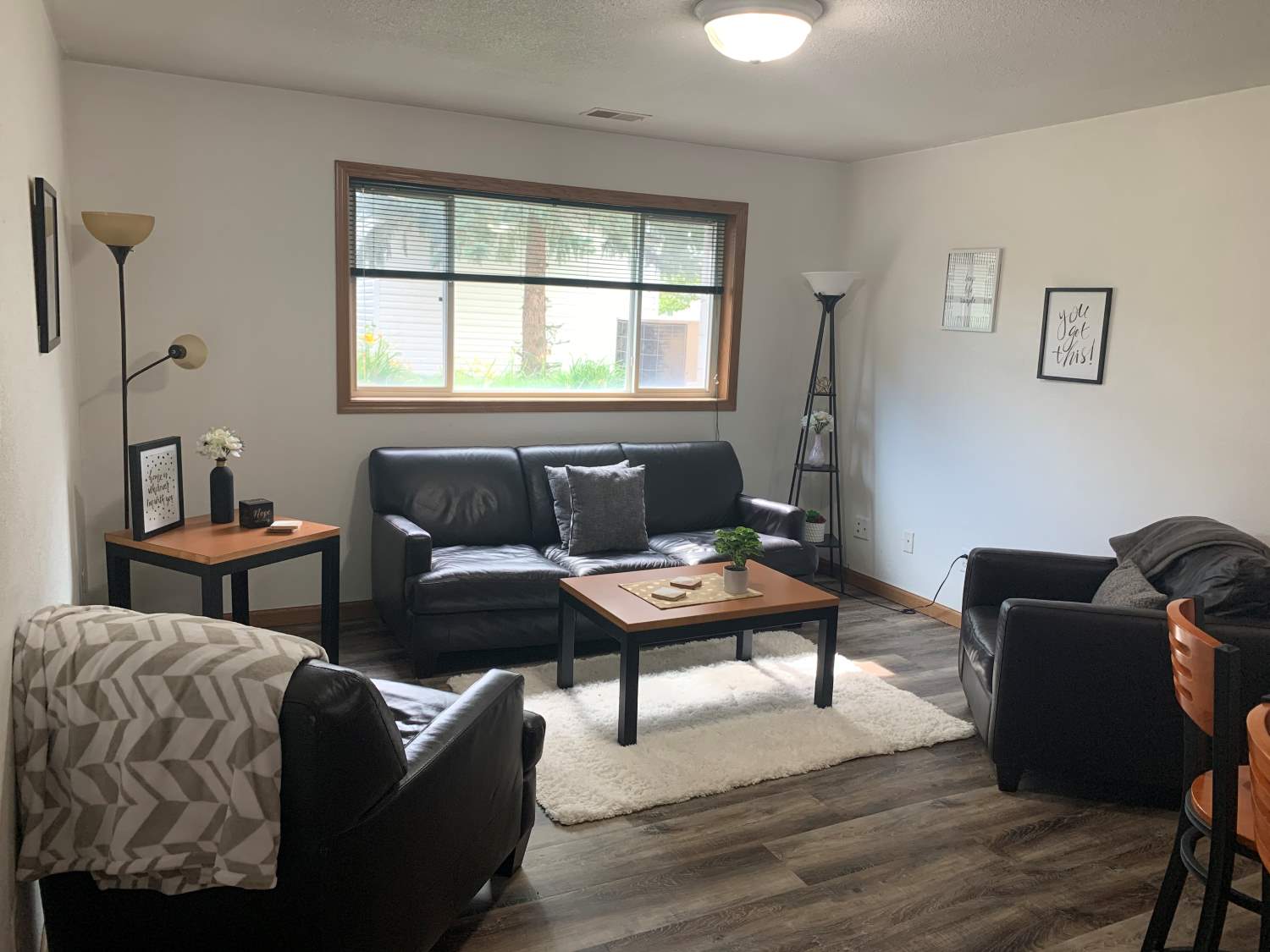 furnished apartment with table, couches and lamp