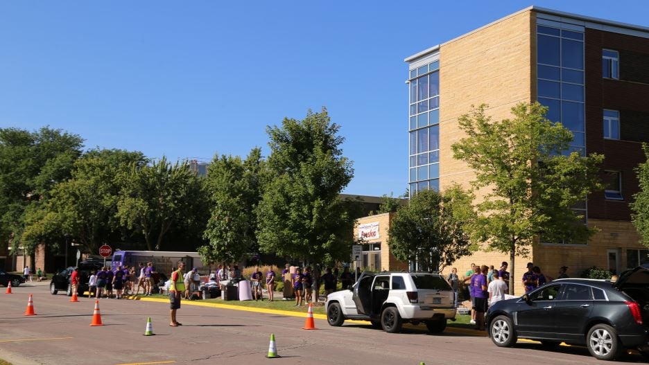 Students parked curbside outside of Preska Residence Community unloading during move-in day