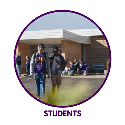 Two students walking outside a building on campus at Minnesota State University, Mankato