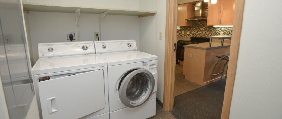 View of utility room with washer and dryer inside the H Hall Resident staff apartment
