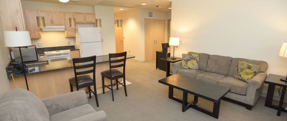 View of living room and kitchen area inside the PS 107 Hall Resident staff apartment