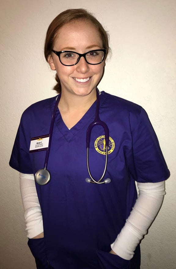 a person wearing a purple scrubs and a stethoscope around her neck