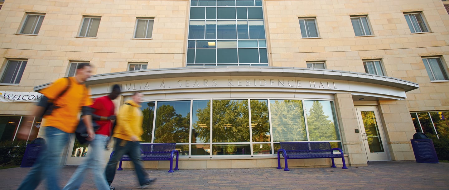 Students walking outside of the Julia Sears residence hall