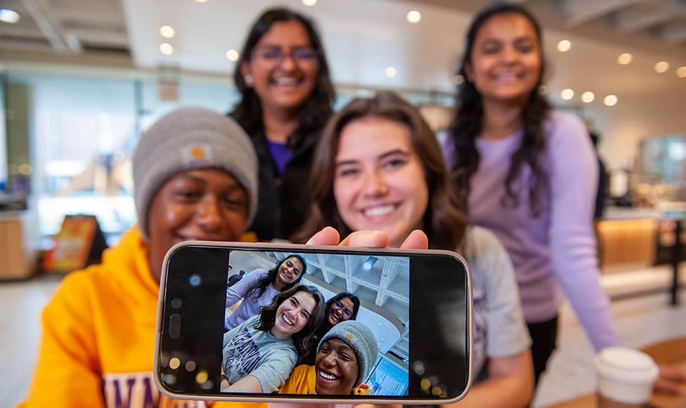 Four students taking a selfie together in the Centennial Student Union
