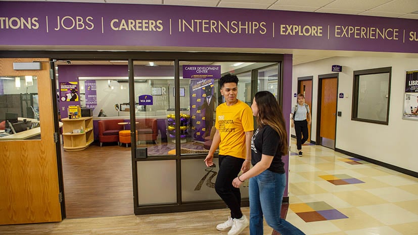 two students talking and walking near the Career Development Center on campus